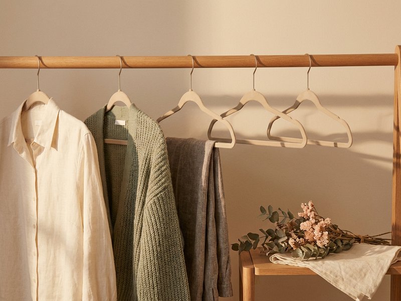 adhd capsule wardrobe — a short rail of neutral clothes on matching hangers, lacedopamine.com
