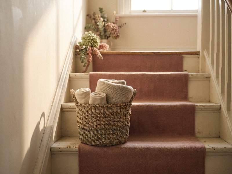 adhd chore chart — a woven basket on a wooden staircase in soft daylight, lacedopamine.com