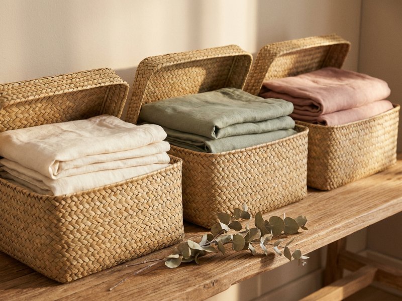 adhd closet organization — open woven baskets of folded clothes on a shelf, lacedopamine.com