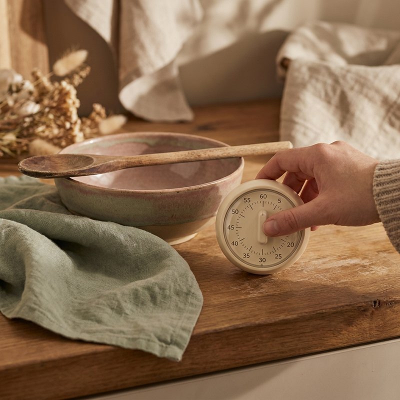 ADHD forget to eat — a small kitchen timer beside a bowl on a warm counter, lacedopamine.com