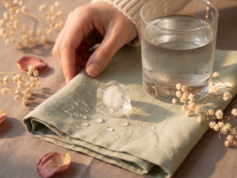 adhd paralysis — an ice cube and a glass of cold water on a linen cloth, lacedopamine.com