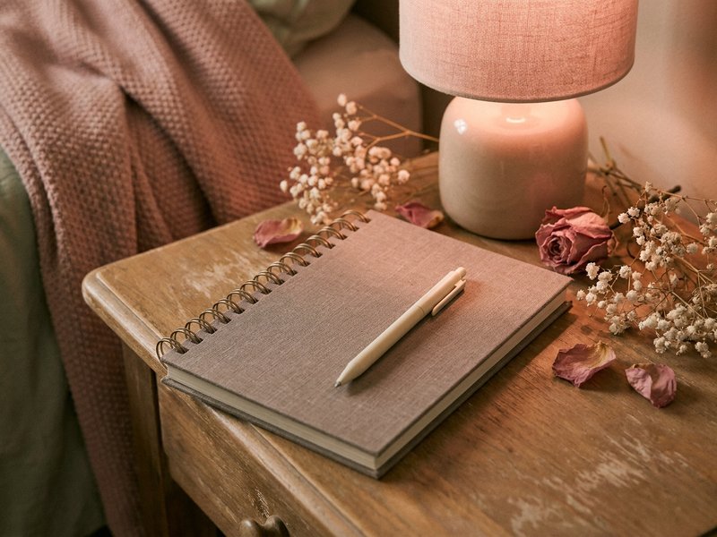 brain dump ideas ADHD — a quiet nightstand with a notebook and soft lamp light, lacedopamine.com