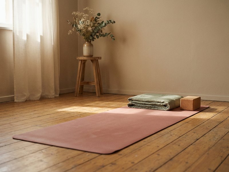 breathwork for adhd — a rolled out yoga mat left waiting on a wooden floor, lacedopamine.com