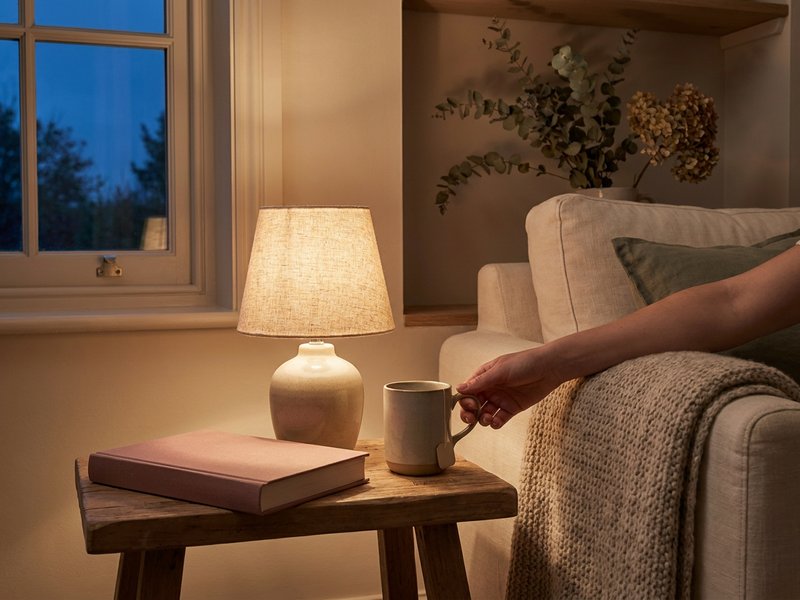 cozy fall evening wind down for fall routine ideas ADHD, lamp and knit throw on a linen sofa, lacedopamine.com