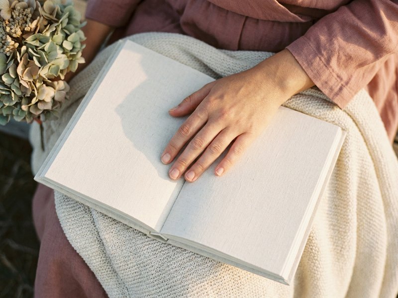evening journal prompts ADHD — a hand resting over a journal page, lacedopamine.com
