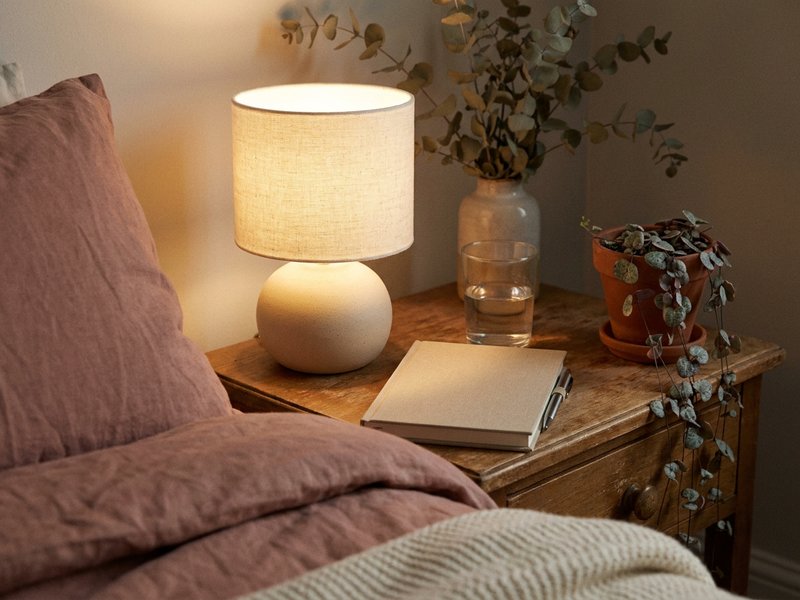 bedside notebook and lamp for fall journaling ADHD, warm autumn light on a wooden nightstand, lacedopamine.com