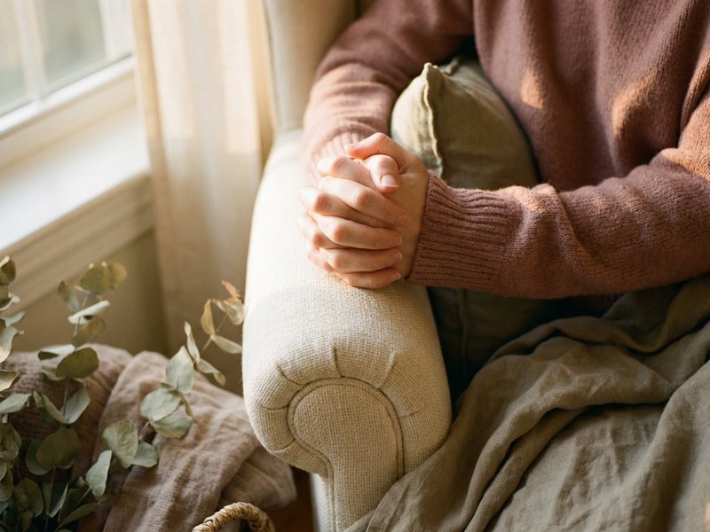 ADHD family gatherings RSD — hands clasped tightly showing physical rejection sensitivity, lacedopamine.com