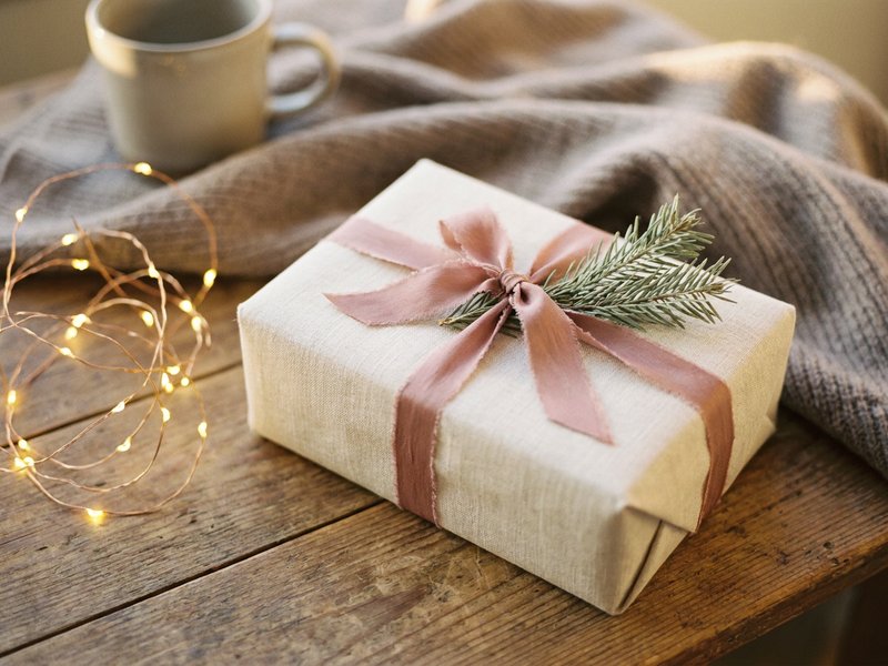 holiday family boundaries ADHD — warm string lights and a wrapped gift, lacedopamine.com