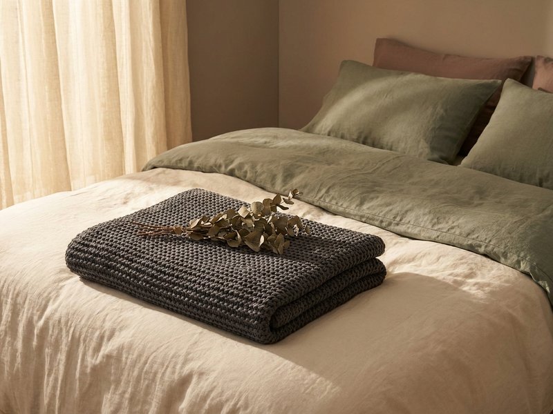 sensory overload recovery ADHD — a weighted blanket folded on a bed, lacedopamine.com