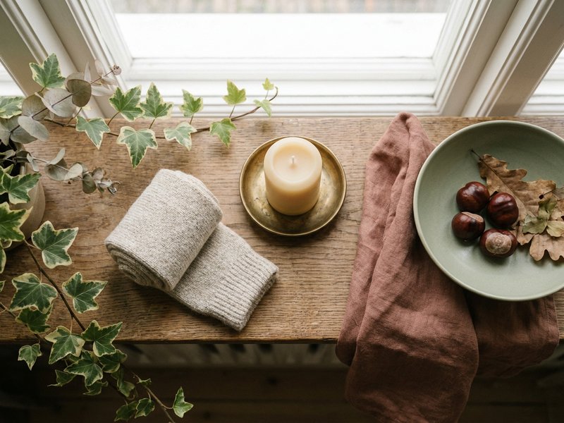 soft autumn sensory corner for fall routine ideas ADHD, wool socks and candle on a wooden shelf, lacedopamine.com
