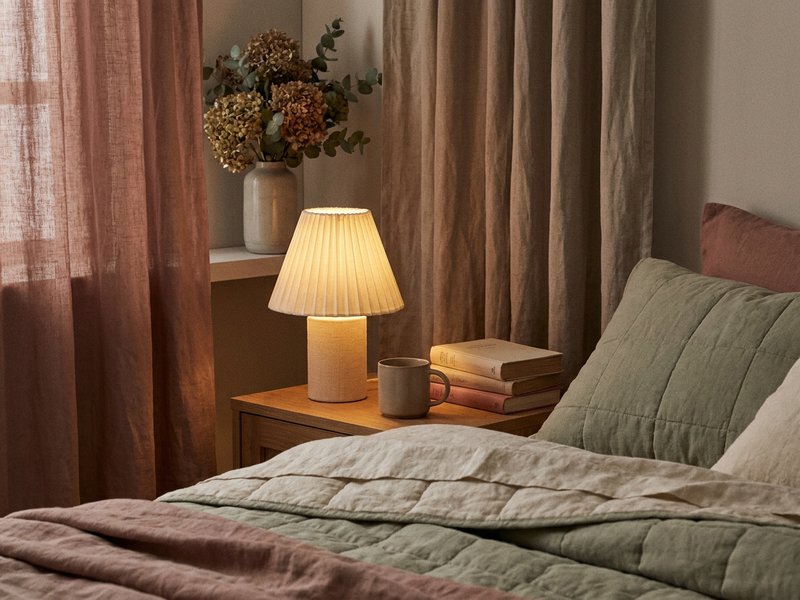 ADHD bedroom setup sleep — a dim bedside lamp glowing in a calm bedroom, lacedopamine.com