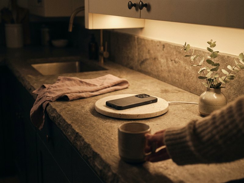 ADHD sleep hygiene mistakes — a phone charging on a kitchen counter at night, screen off, lacedopamine.com