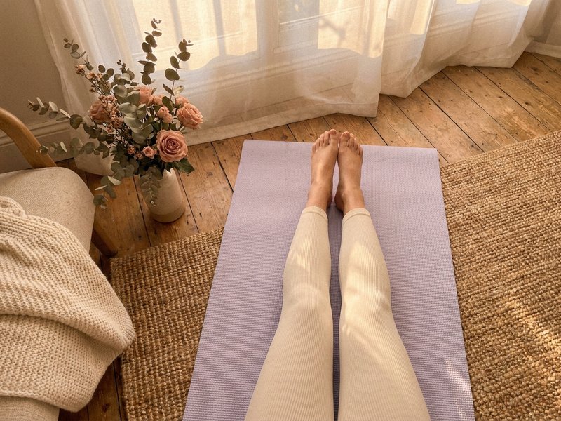 ADHD workout mistakes — a person stretching on a yoga mat at home, lacedopamine.com