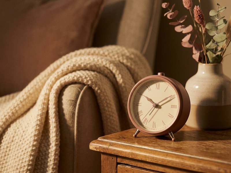 magnesium vs melatonin for ADHD sleep — a small alarm clock on a nightstand at night, lacedopamine.com