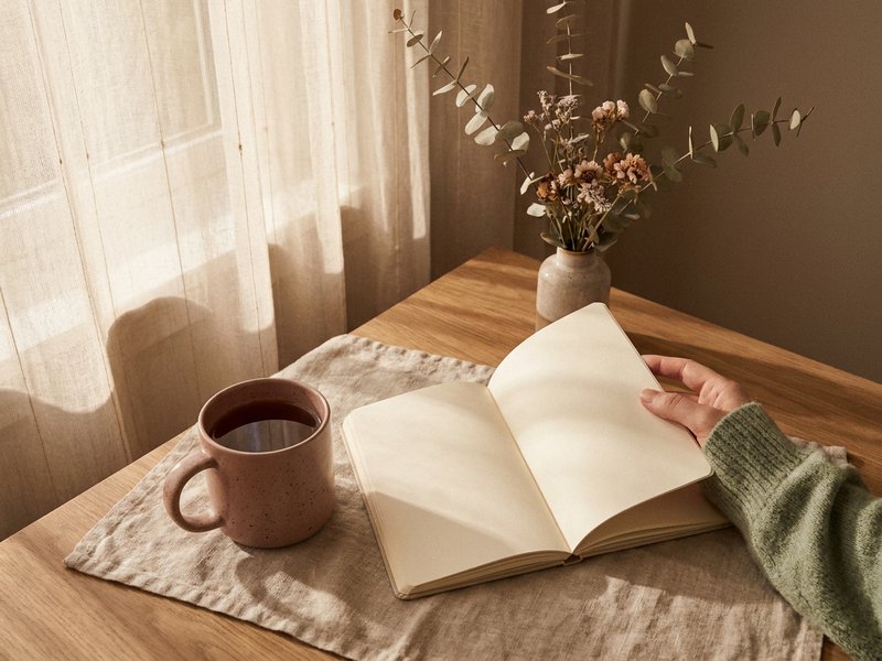 morning pages ADHD — a cup of tea beside an open blank notebook, lacedopamine.com