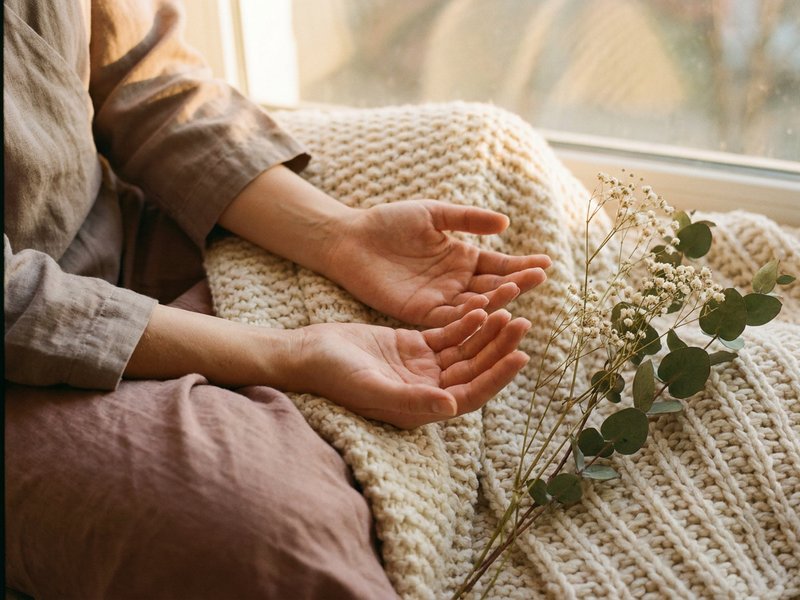 processing ADHD diagnosis — two open hands resting on a lap in soft daylight, lacedopamine.com