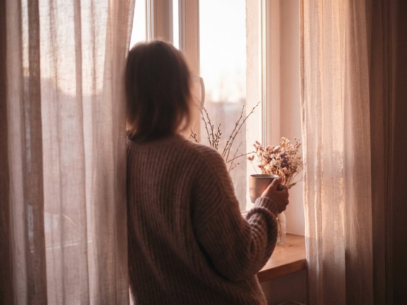 processing ADHD diagnosis — a woman's silhouette resting against a sunlit window, lacedopamine.com